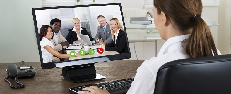 Young Businesswoman Videochatting With Colleagues On Computer In Office